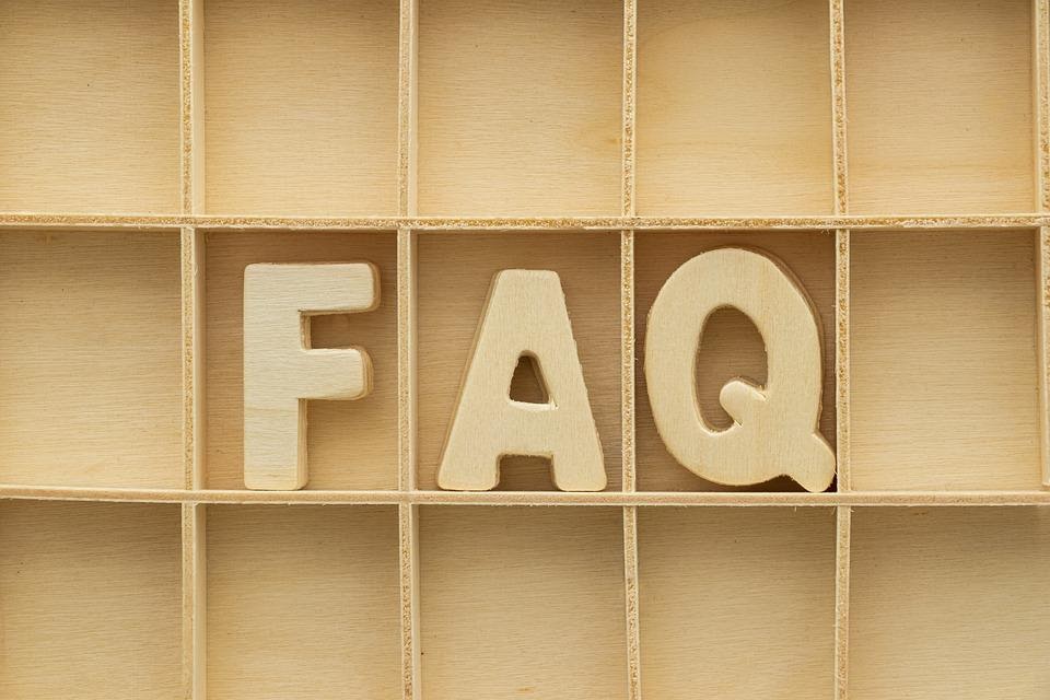 A wooden cut out displaying the letters F, A and Q