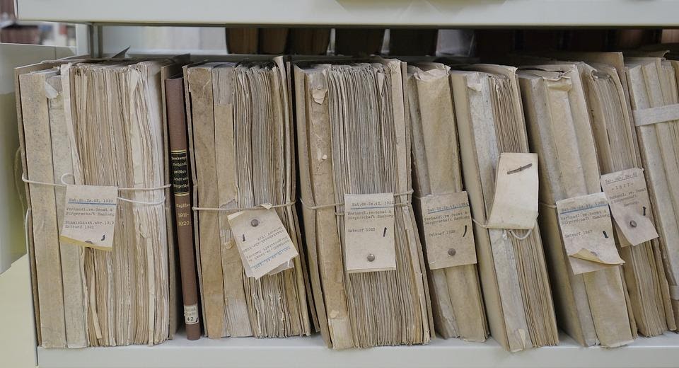 Some health records in folders on a bookshelf