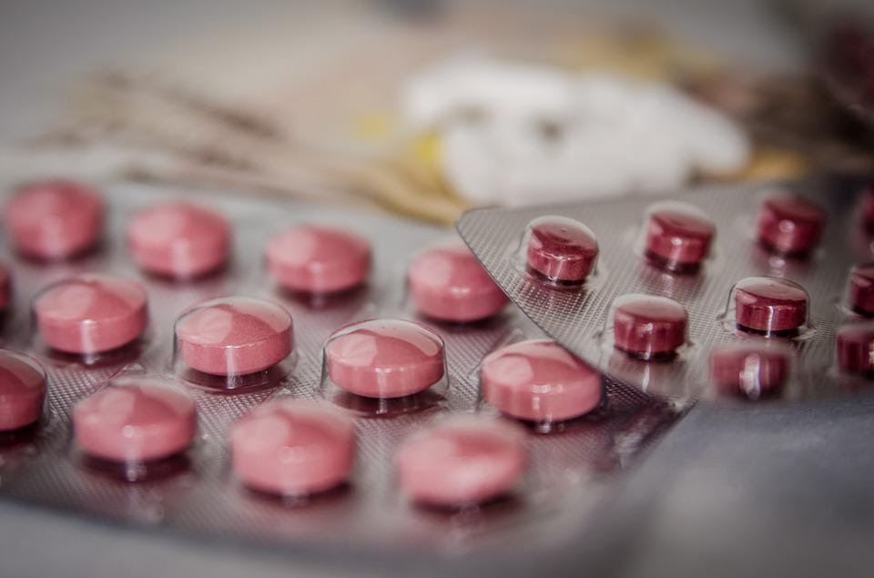 A close-up of red tablets in their packaging