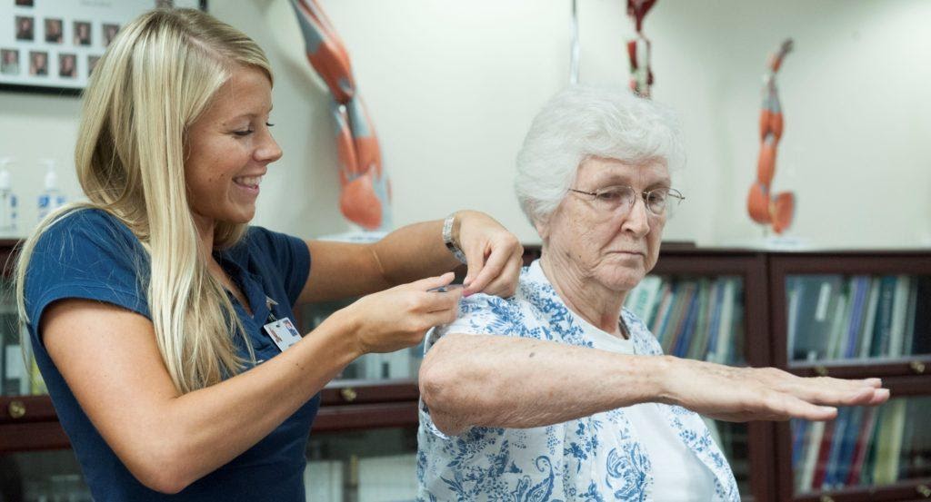 An occupational therapist working with an elderly patient