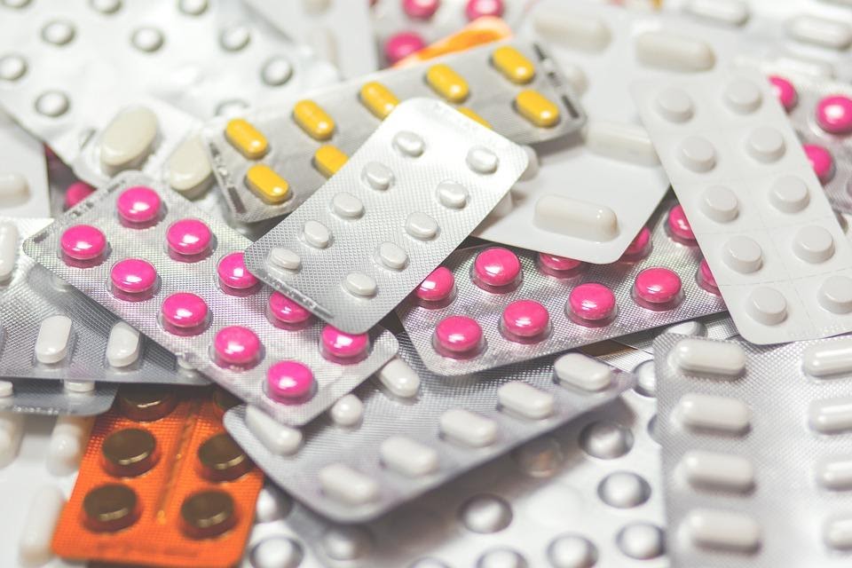 A pile of various tablets of all shapes, sizes and colours in their packets