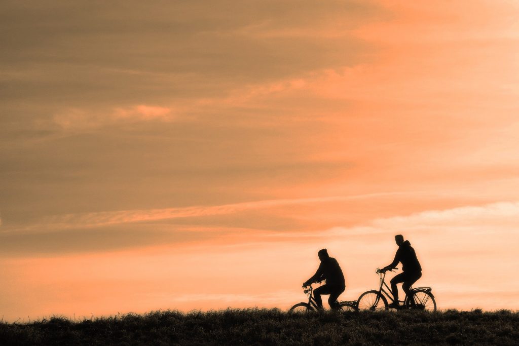 Two cyclists at sunset.