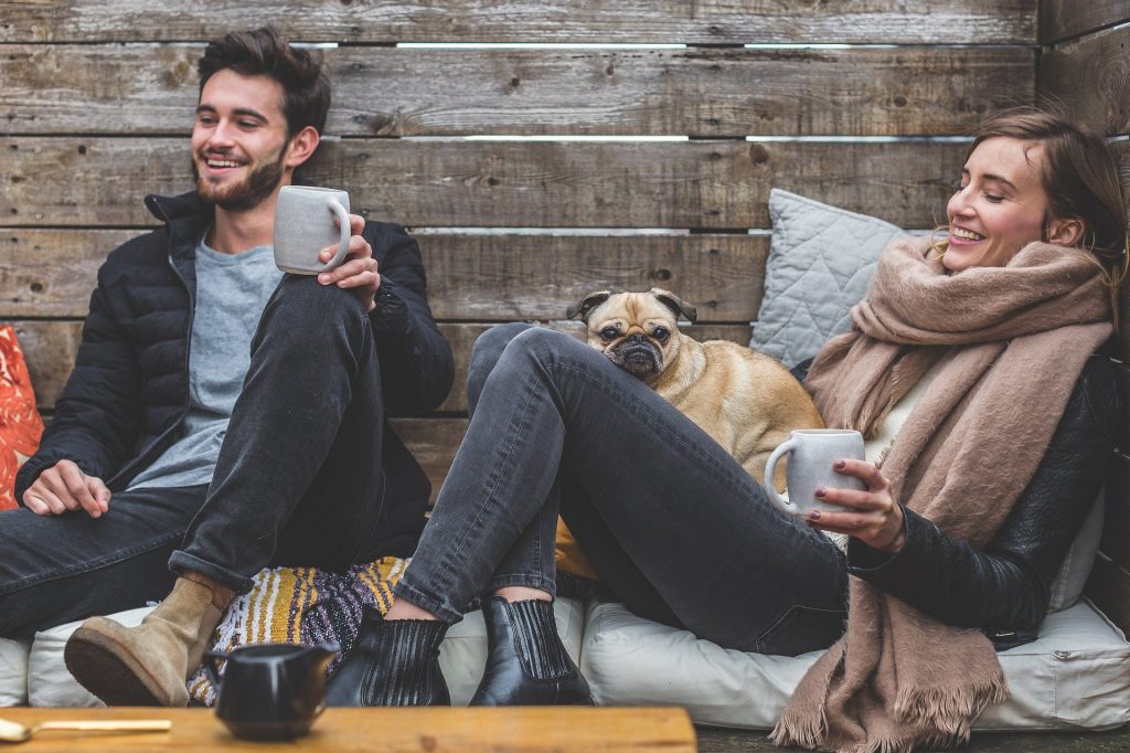 Man and woman with dog talking.