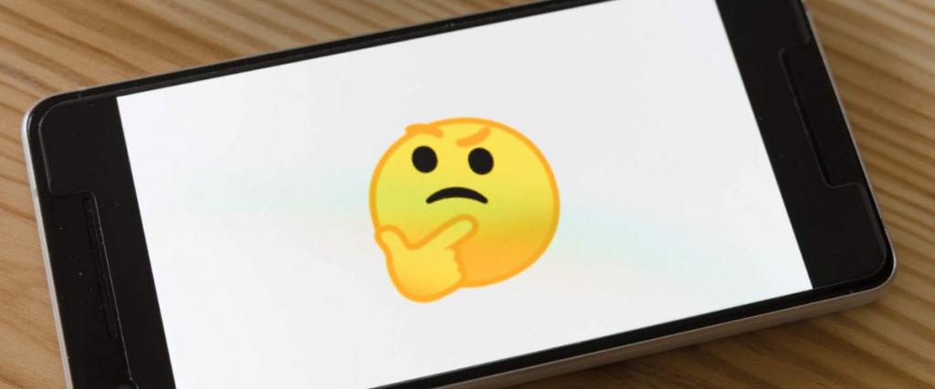Mobile phone showing thinking emoji.