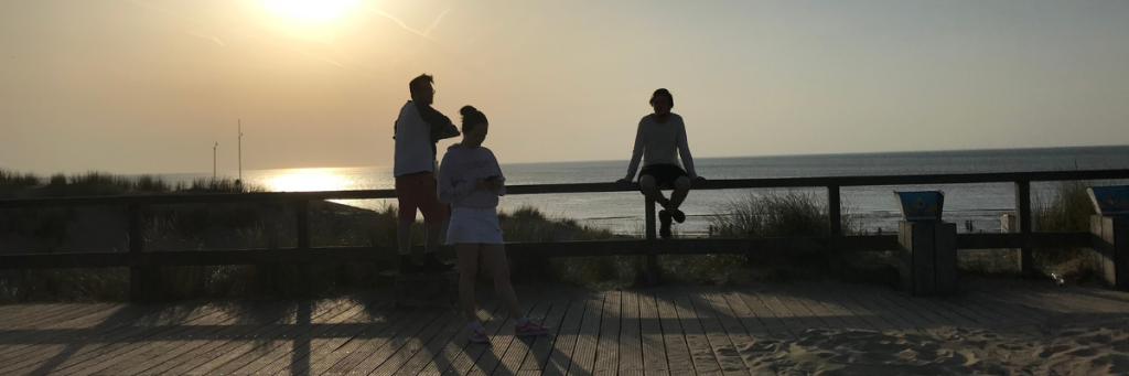 teenagers on the beach at sunset