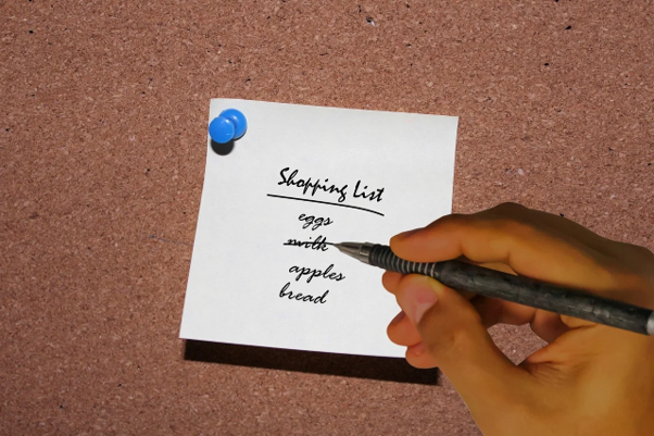 Aa person crossing their shopping list out.