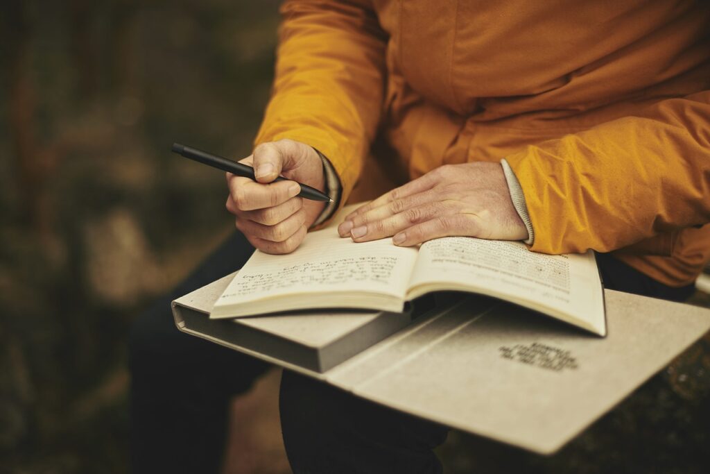A person writing in a notebook.