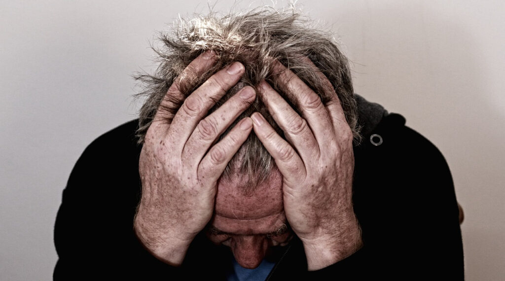 a person with their head in their hands.