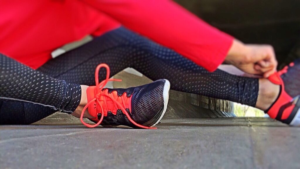 A person putting a pair of trainers on.