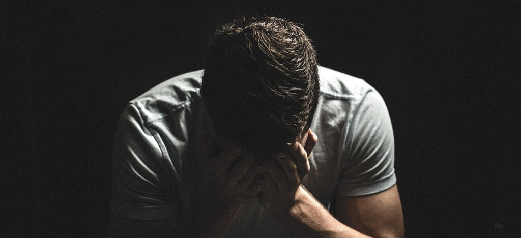 a person with their head in their hands.