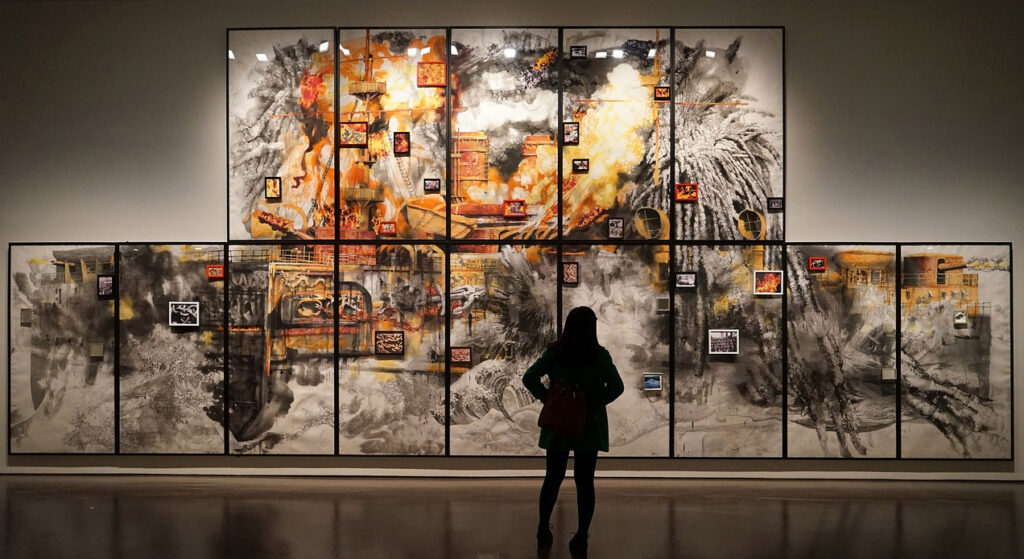 A person looking at a picture in a museum.
