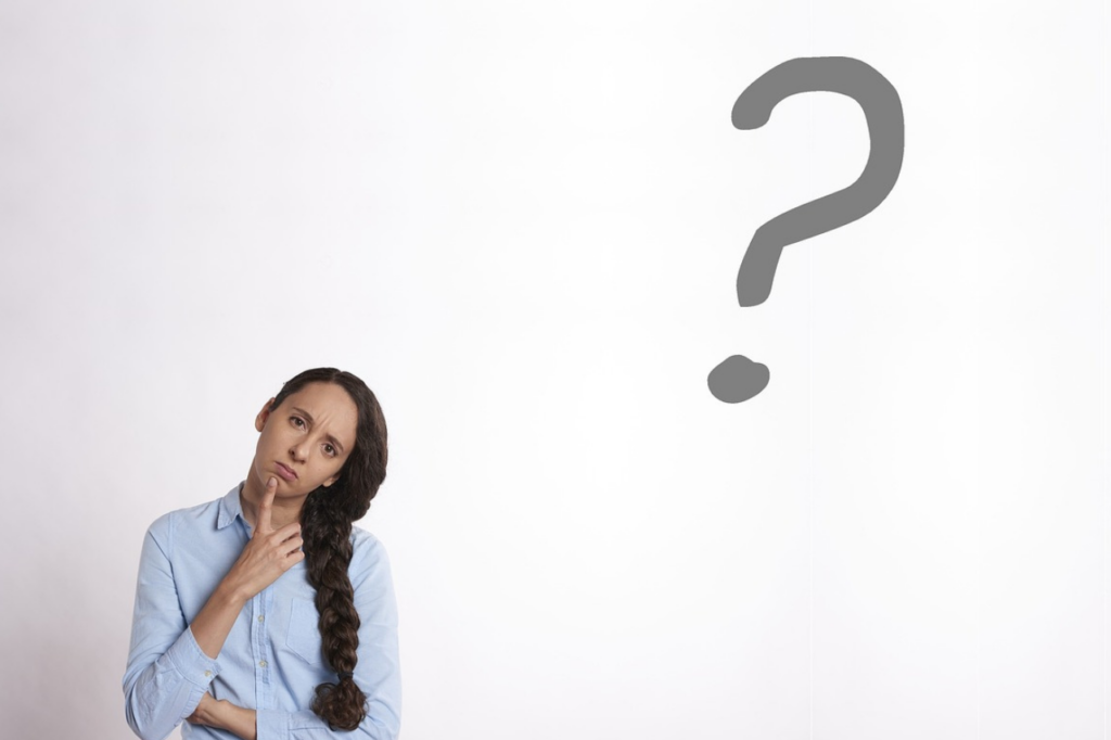a person looking puzzled with a question mark next to them.