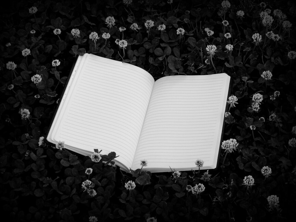 A notebook amongst flowers.