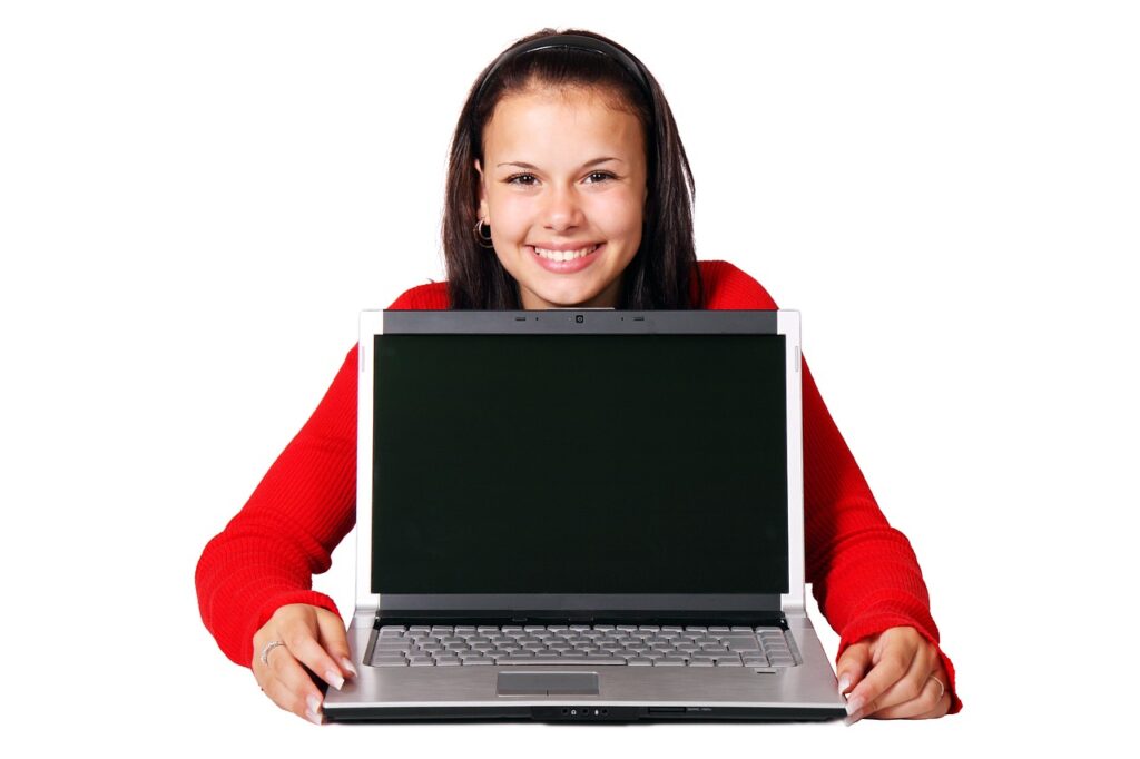 a young person holding a laptop.