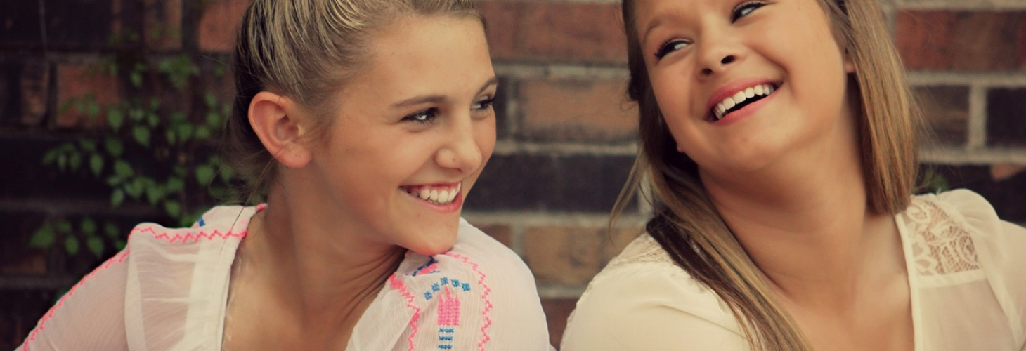 two young people laughing.