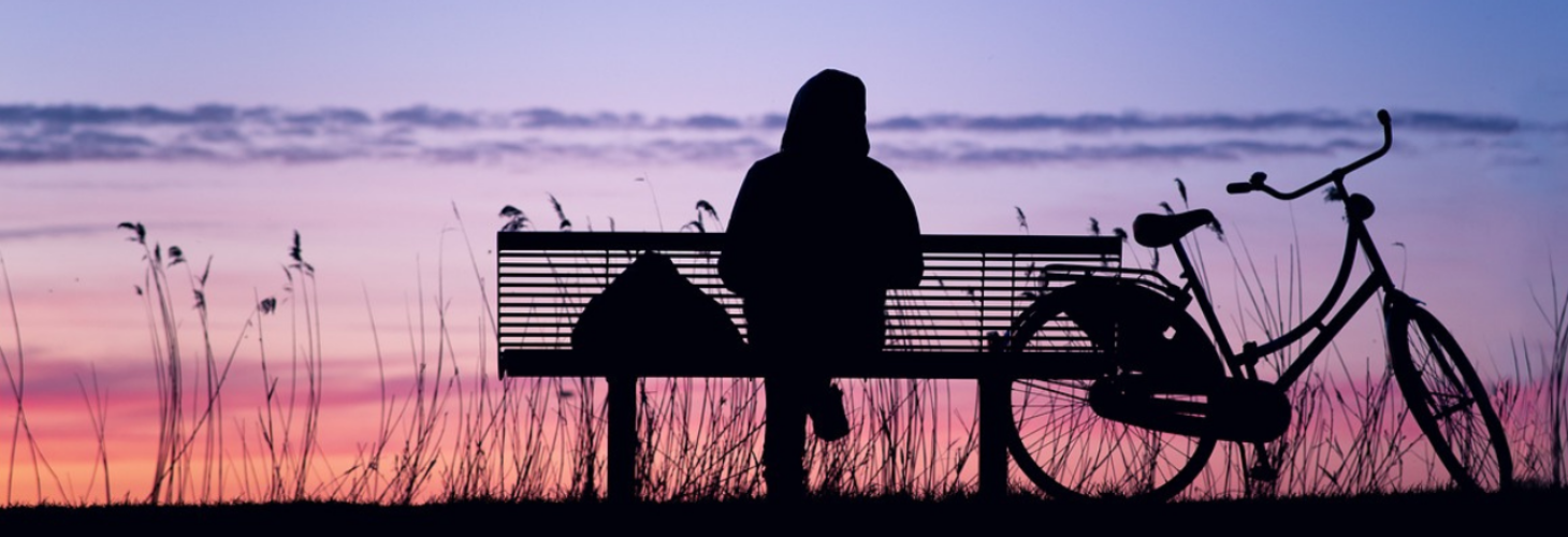 a person sat alone on a bench.