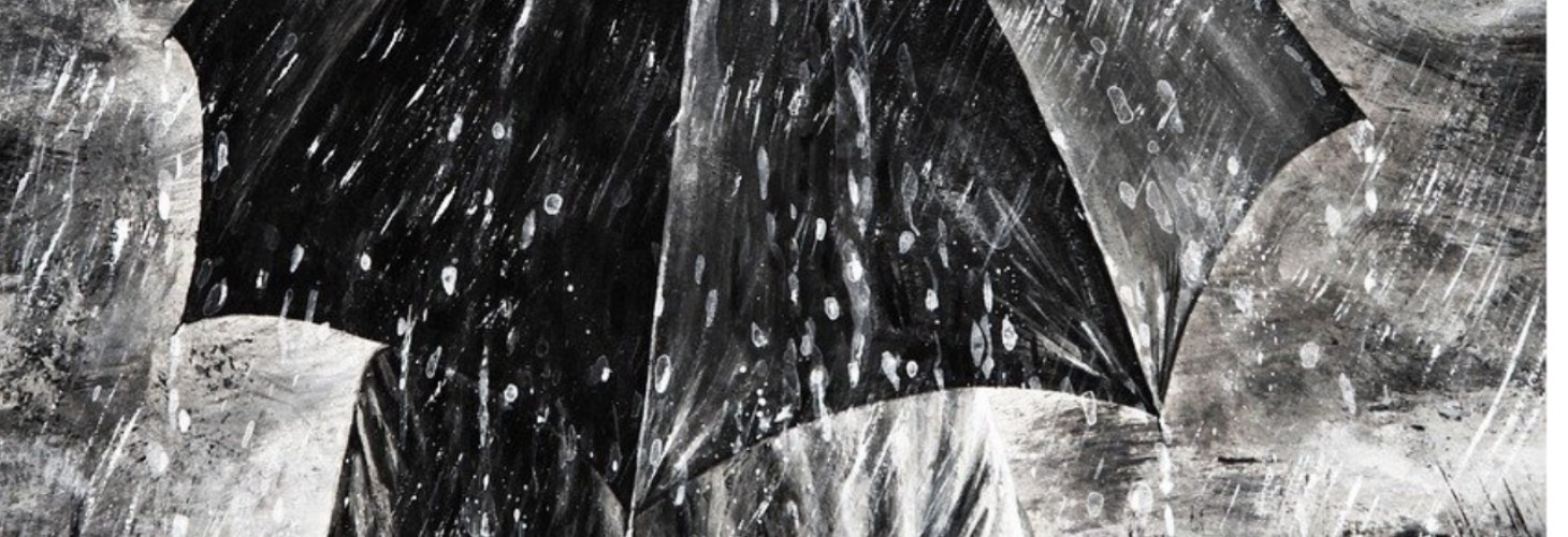 A person standing under an umbrella on a rainy day