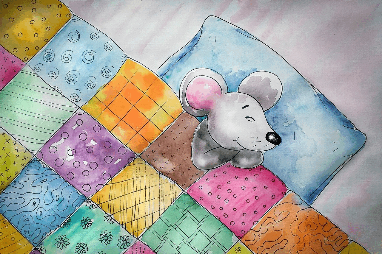 A mouse asleep in a bed