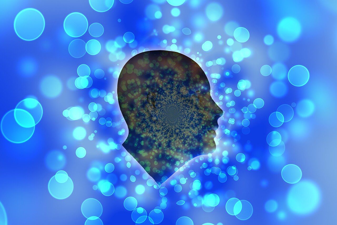 An outline of a head with lots of bubbles around it.