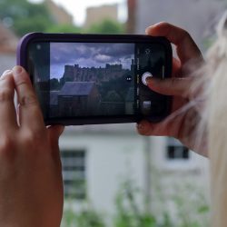 Girl taking photo of the view on mobile phone