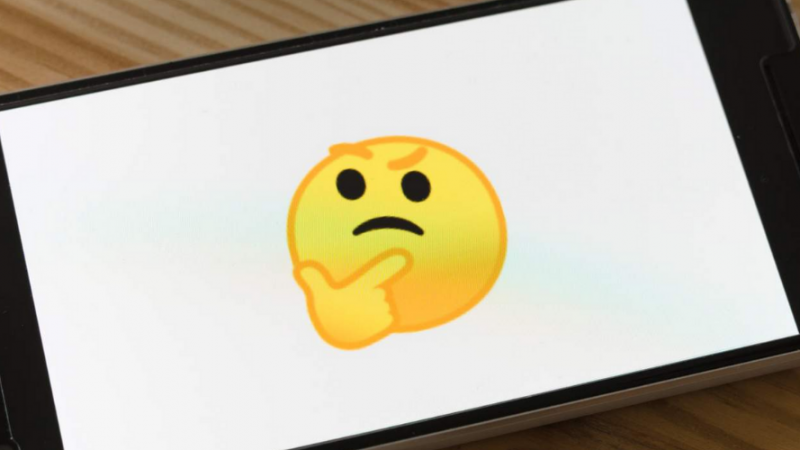 a mobile phone with a thinking emoji