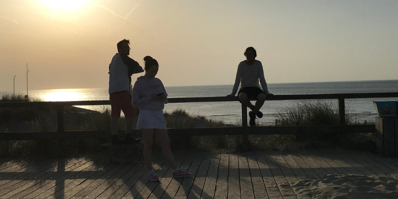 people at the beach at sunset